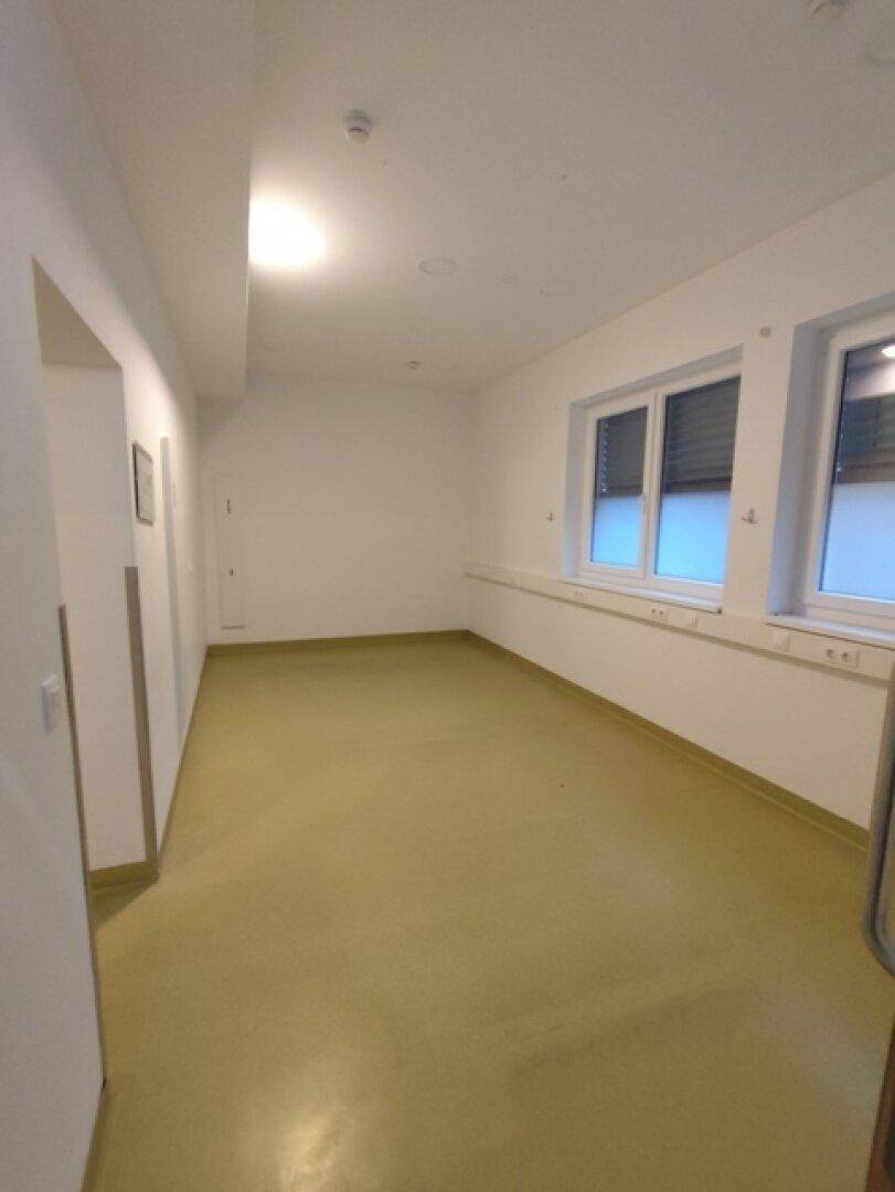 Geräumiger Büroraum mit großen Fenstern und hellem Boden, ideal für eine flexible Arbeitsplatzgestaltung.