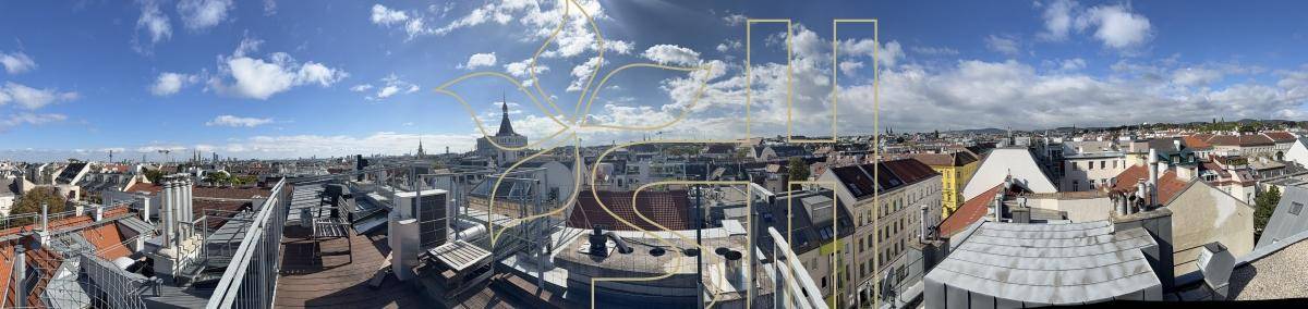 Weitläufiger Panoramablick über die Dächer der Stadt unter einem strahlend blauen Himmel.
