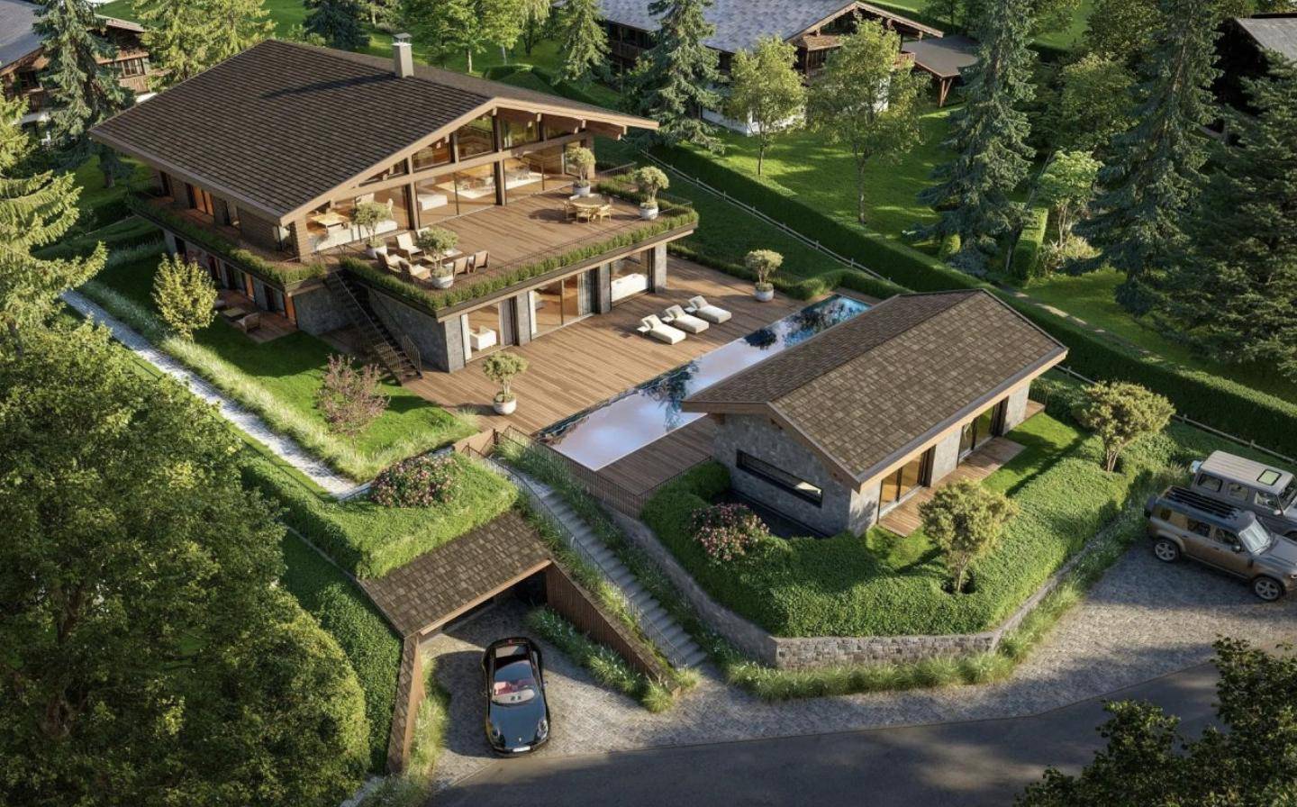 Vogelperspektive eines luxuriösen Anwesens mit Hauptgebäude, Gästehaus und weitläufiger Außenanlage.