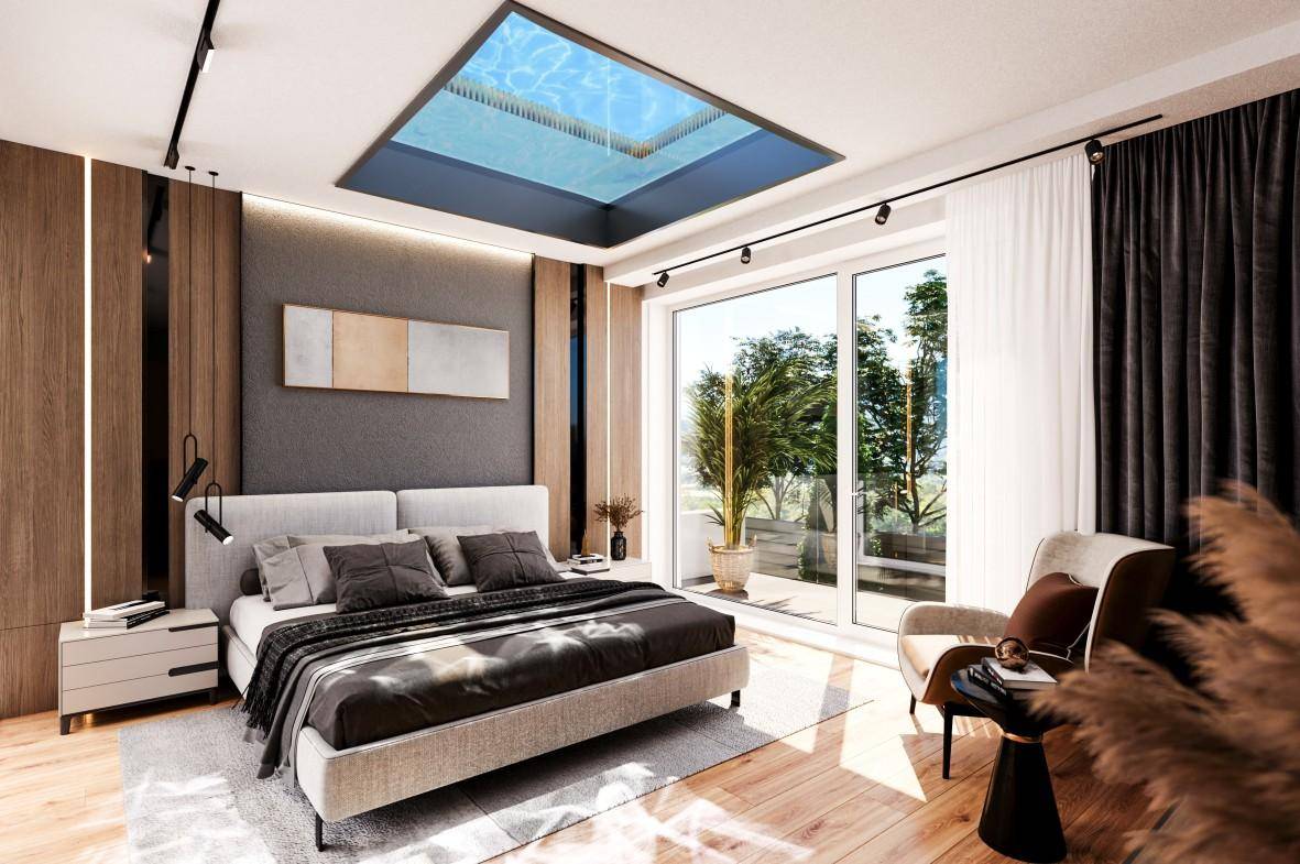 Modernes Schlafzimmer mit großem Bett, Holzboden und einem einzigartigen Deckenfenster mit Blick auf Wasser.