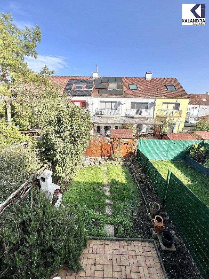 Vogelperspektive auf die Gärten der Reihenhäuser mit Solaranlagen auf den Dächern.