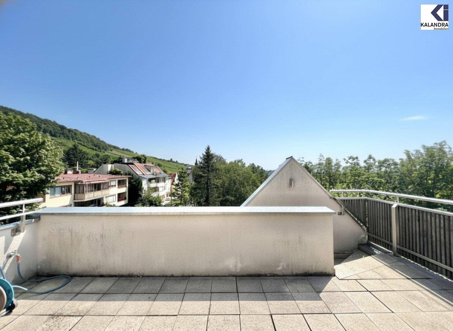 Weitläufige Terrasse mit freiem Blick auf die grüne Hügellandschaft.