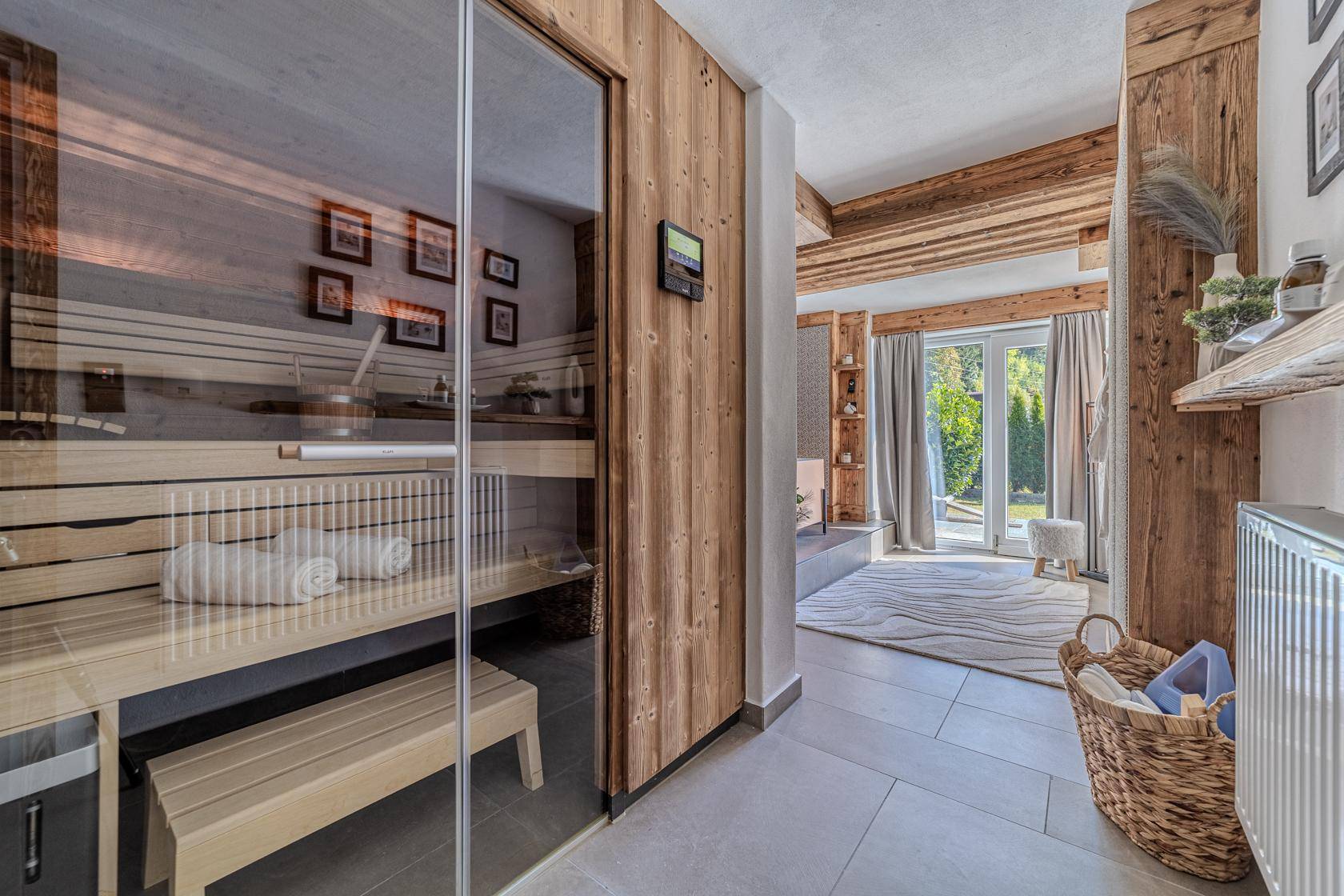 Privater Wellnessbereich mit moderner Sauna und Zugang zu einem Außenbereich.