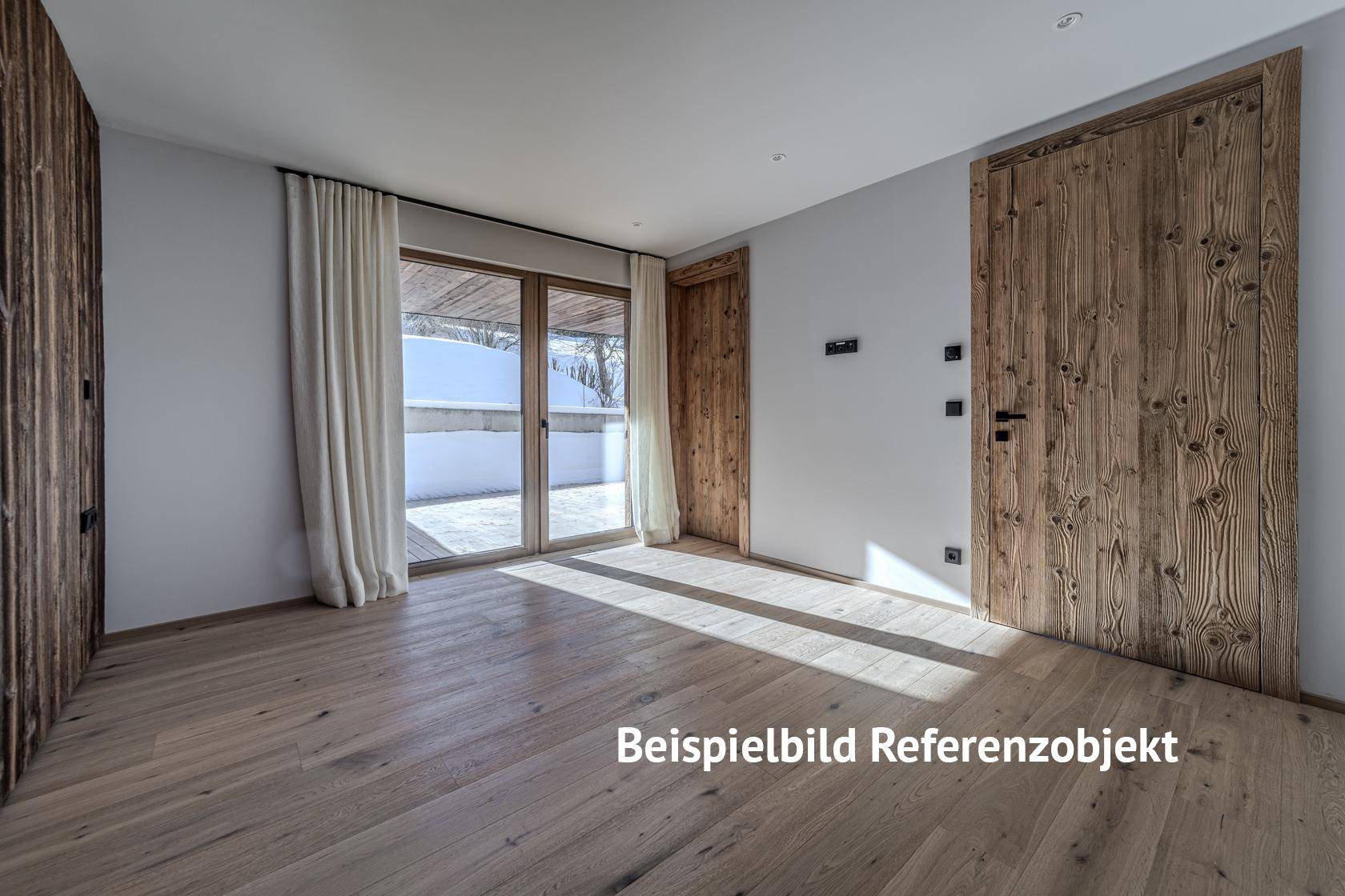 Leerer Raum mit Holzboden, Holztüren und Zugang zu einer Terrasse.
