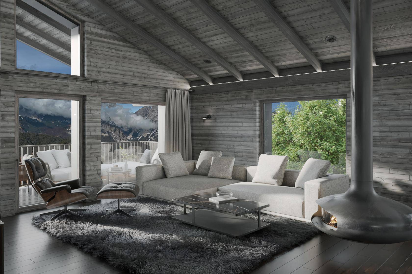 Heller Wohnbereich mit gemütlichem Sofa, modernem Kamin und weitem Blick auf die umliegende Bergwelt.