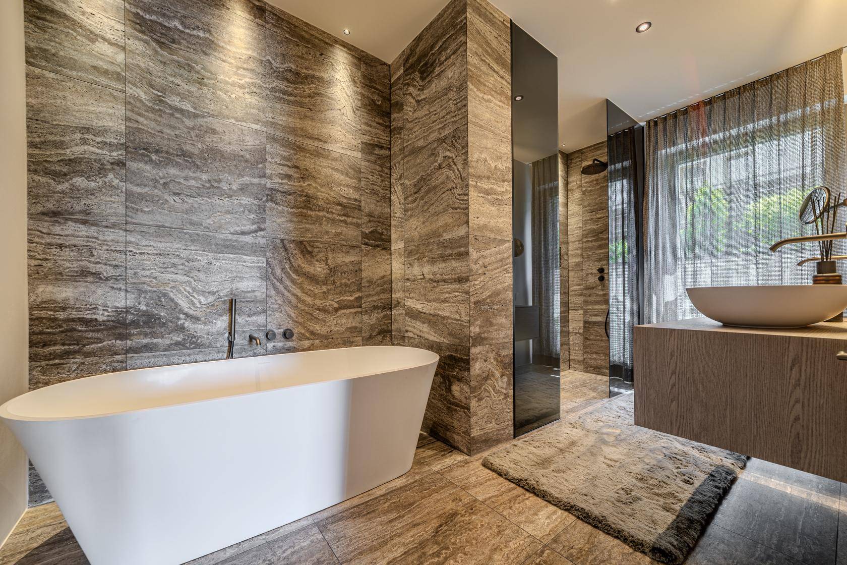 Geräumiges Badezimmer mit freistehender Badewanne, begehbarer Dusche und modernem Design.