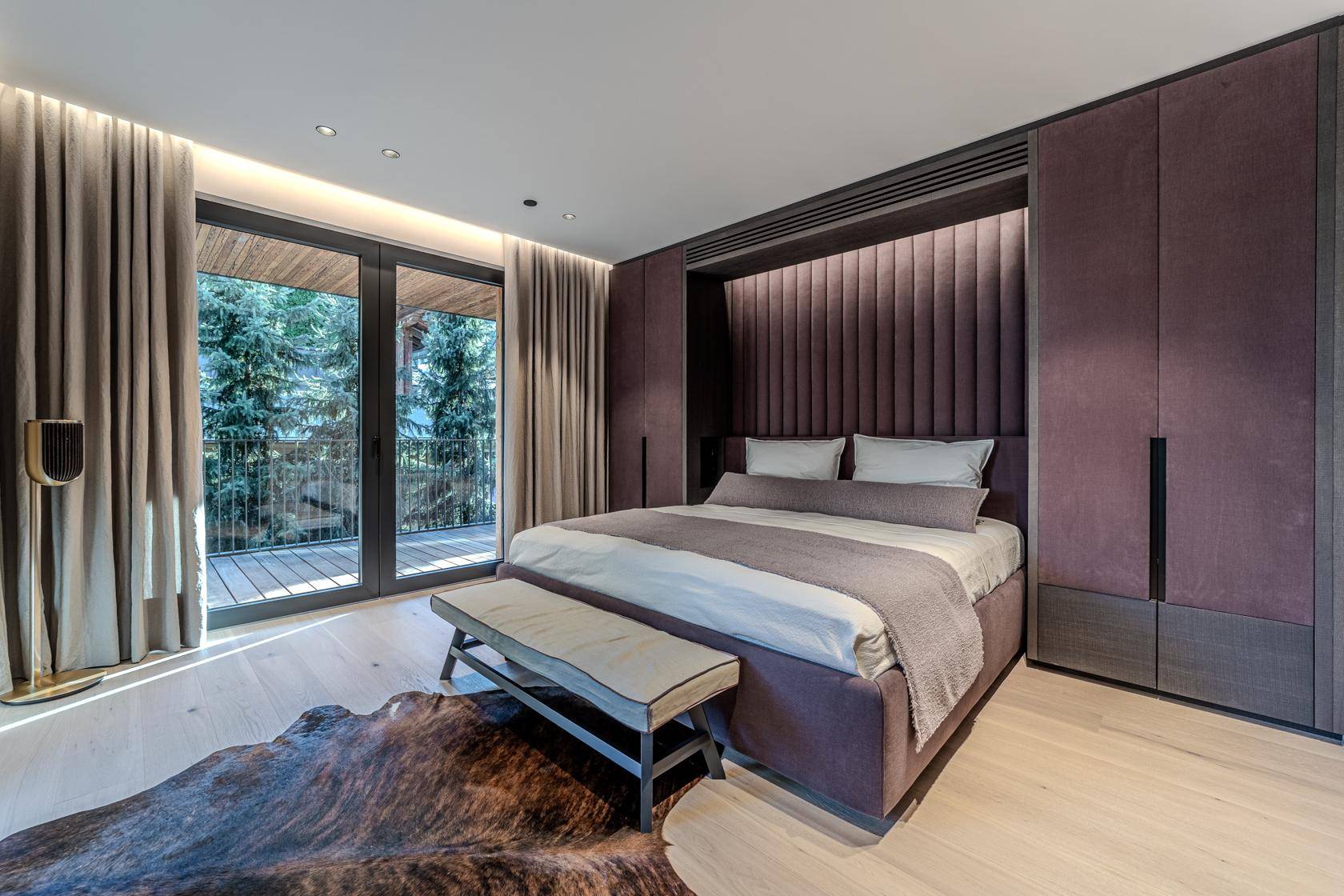 Elegantes Schlafzimmer mit lila Akzenten, Einbauschränken und direktem Zugang zum Balkon.