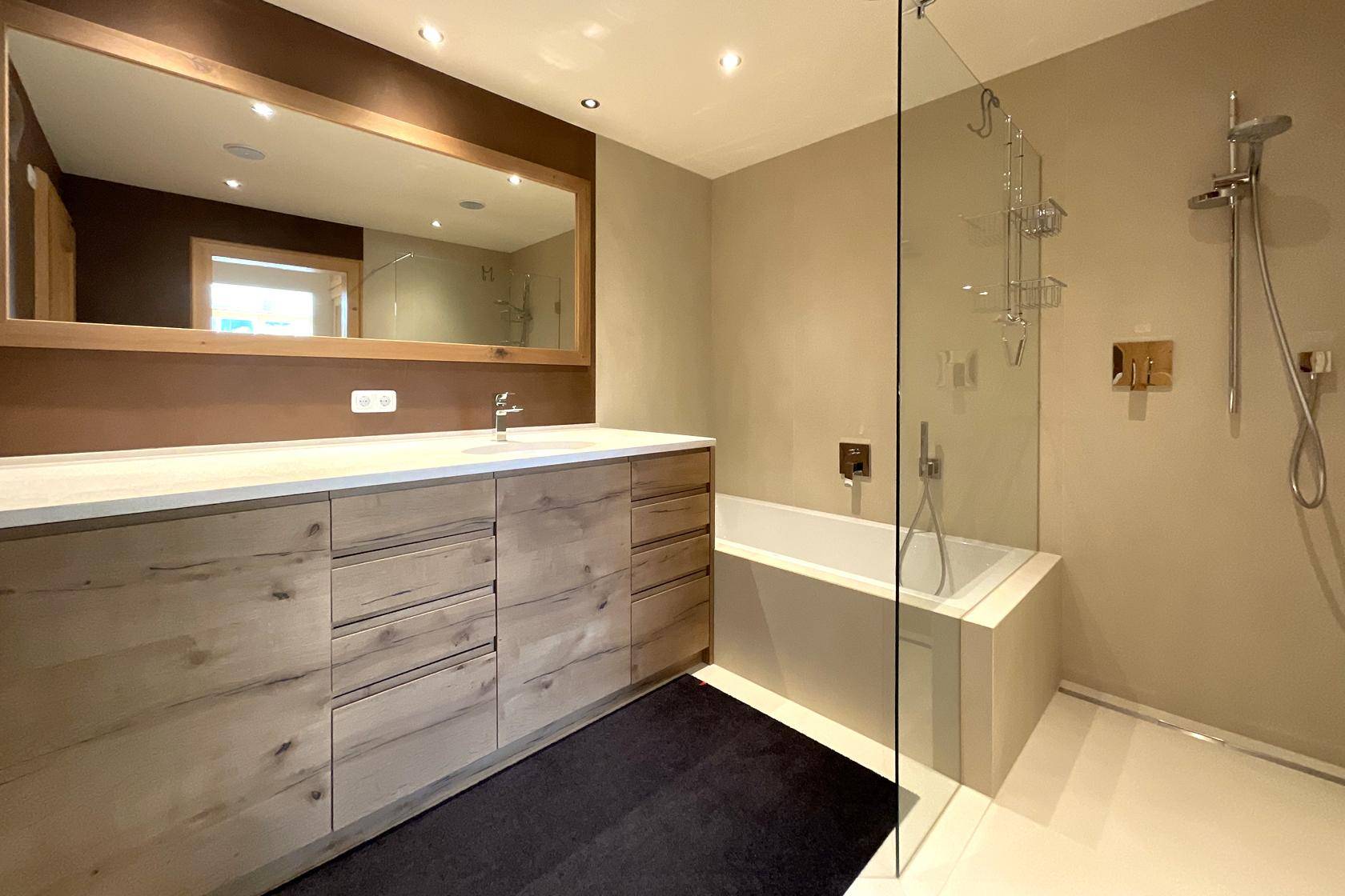 Modernes Badezimmer mit großem Waschtisch, Badewanne und begehbarer Dusche.