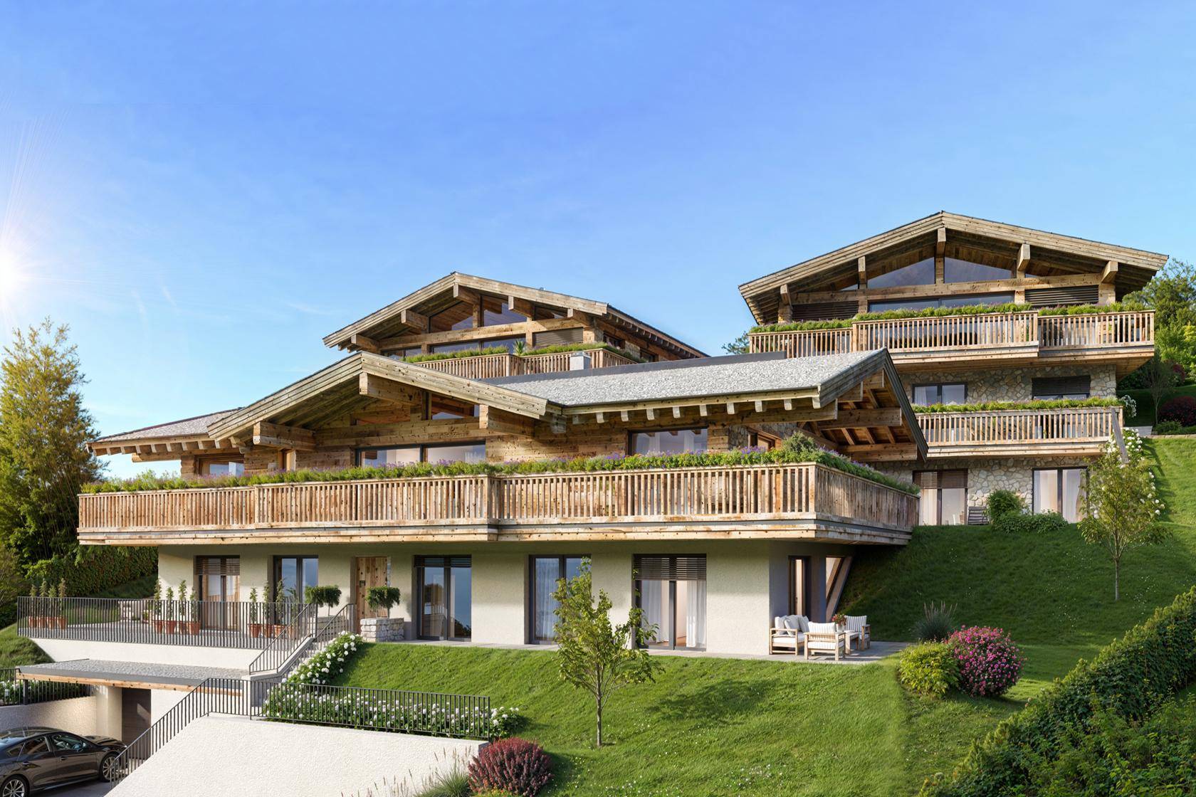 Attraktives Chalet-Gebäude mit Holzfassade und Balkonen, harmonisch in die alpine Landschaft integriert.
