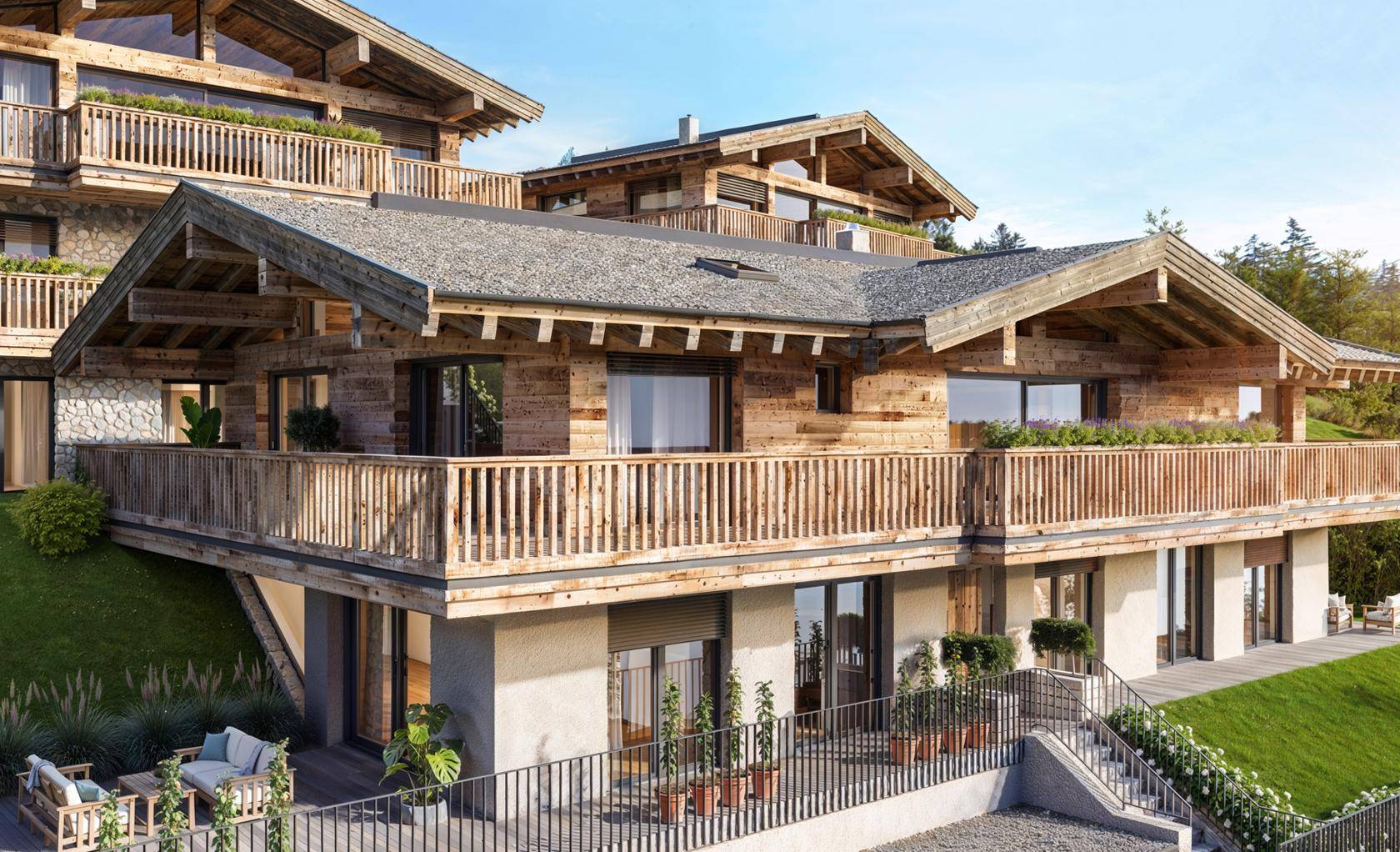 Detailansicht der modernen Chalet-Fassade mit Holzverkleidung, Balkonen und großen Fenstern.