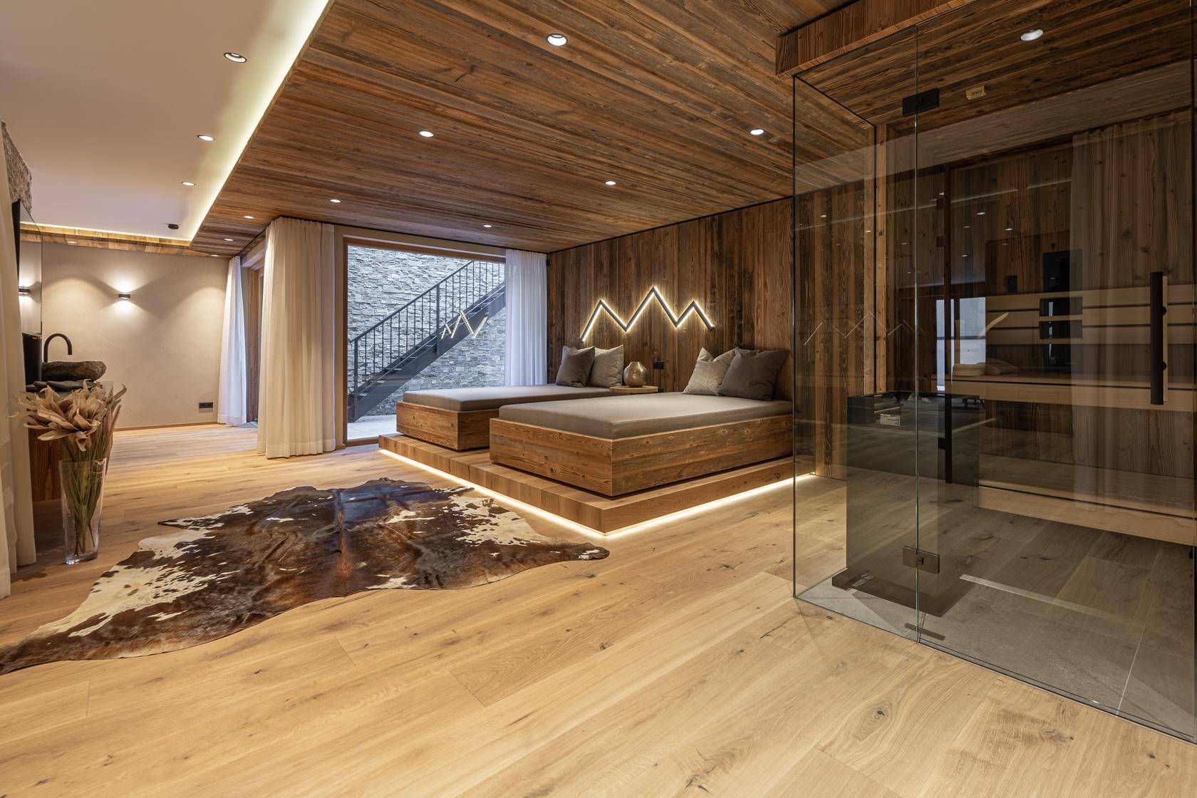 Entspannender Wellnessbereich mit Sauna, Liegeflächen und Holzboden.