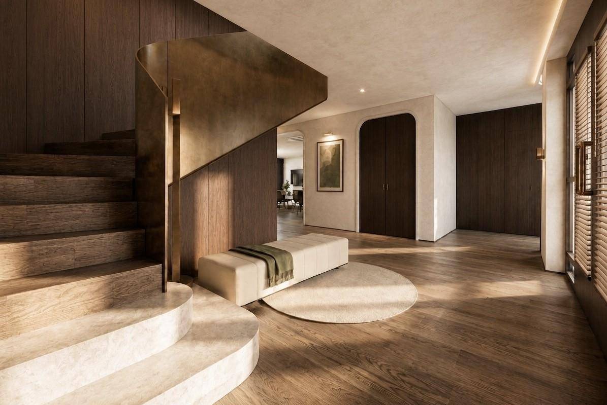 Eleganter Eingangsbereich mit geschwungener Steintreppe, Holzboden und minimalistischer Einrichtung.