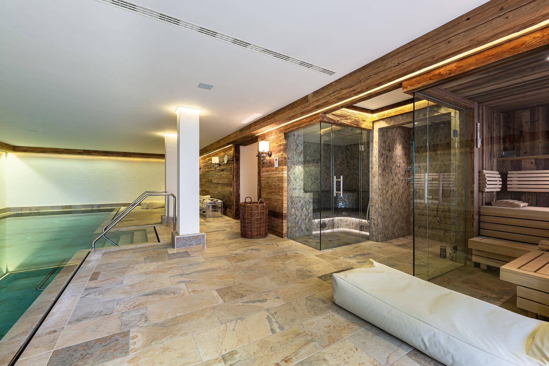 Exklusiver Wellnessbereich mit Innenpool, Sauna und Dampfdusche für Entspannung.