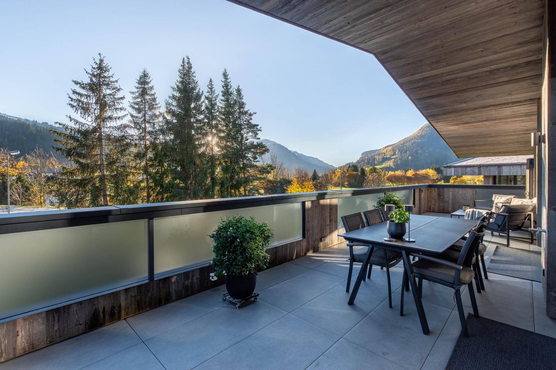 Helle Terrasse mit Essbereich und atemberaubendem Panoramablick auf die Berge und das Tal.
