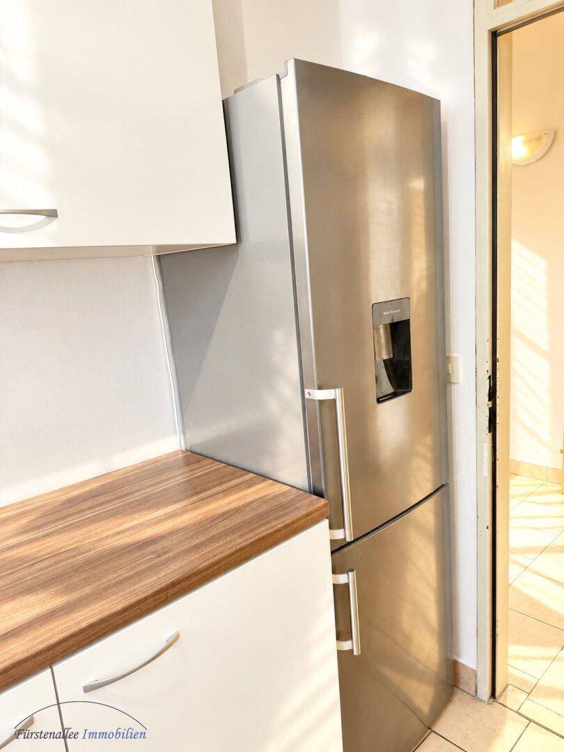 Moderner Kühlschrank mit Gefrierfach und integriertem Wasserspender, praktisch für den täglichen Gebrauch.