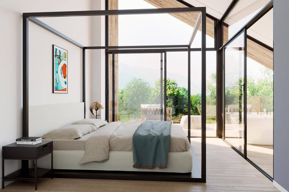 Helles Schlafzimmer mit modernem Himmelbett, Holzboden und großen Fenstern mit Blick ins Grüne.