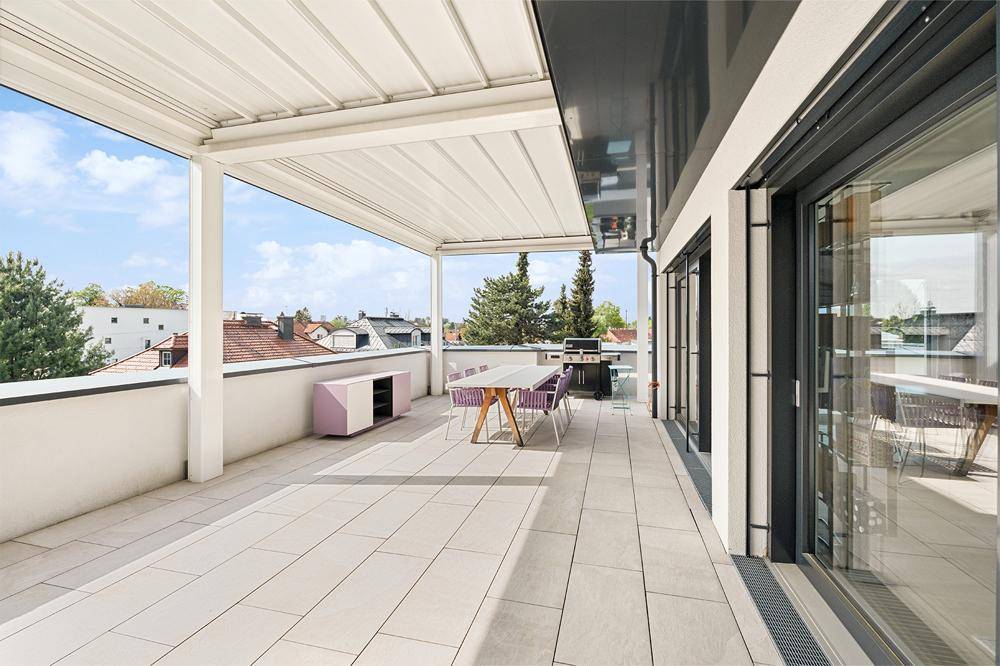 Großzügige Dachterrasse mit Essbereich, Grill und weitem Blick über die Stadt.