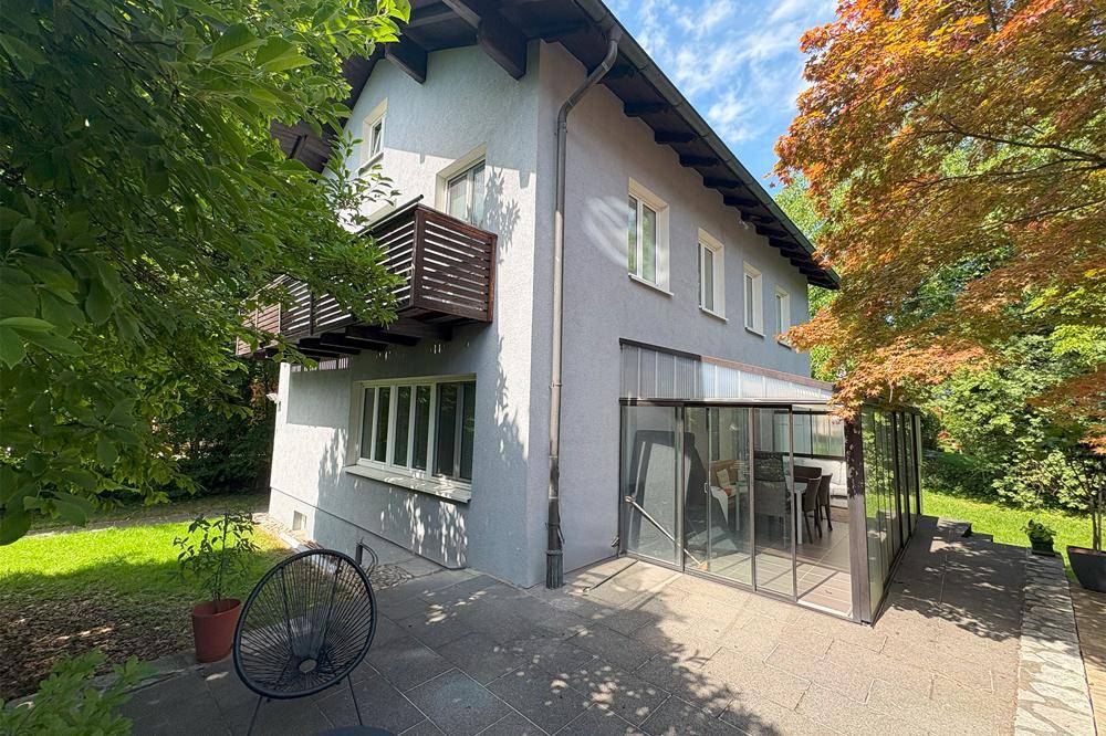 Blick von der Terrasse auf das Haus mit Wintergarten