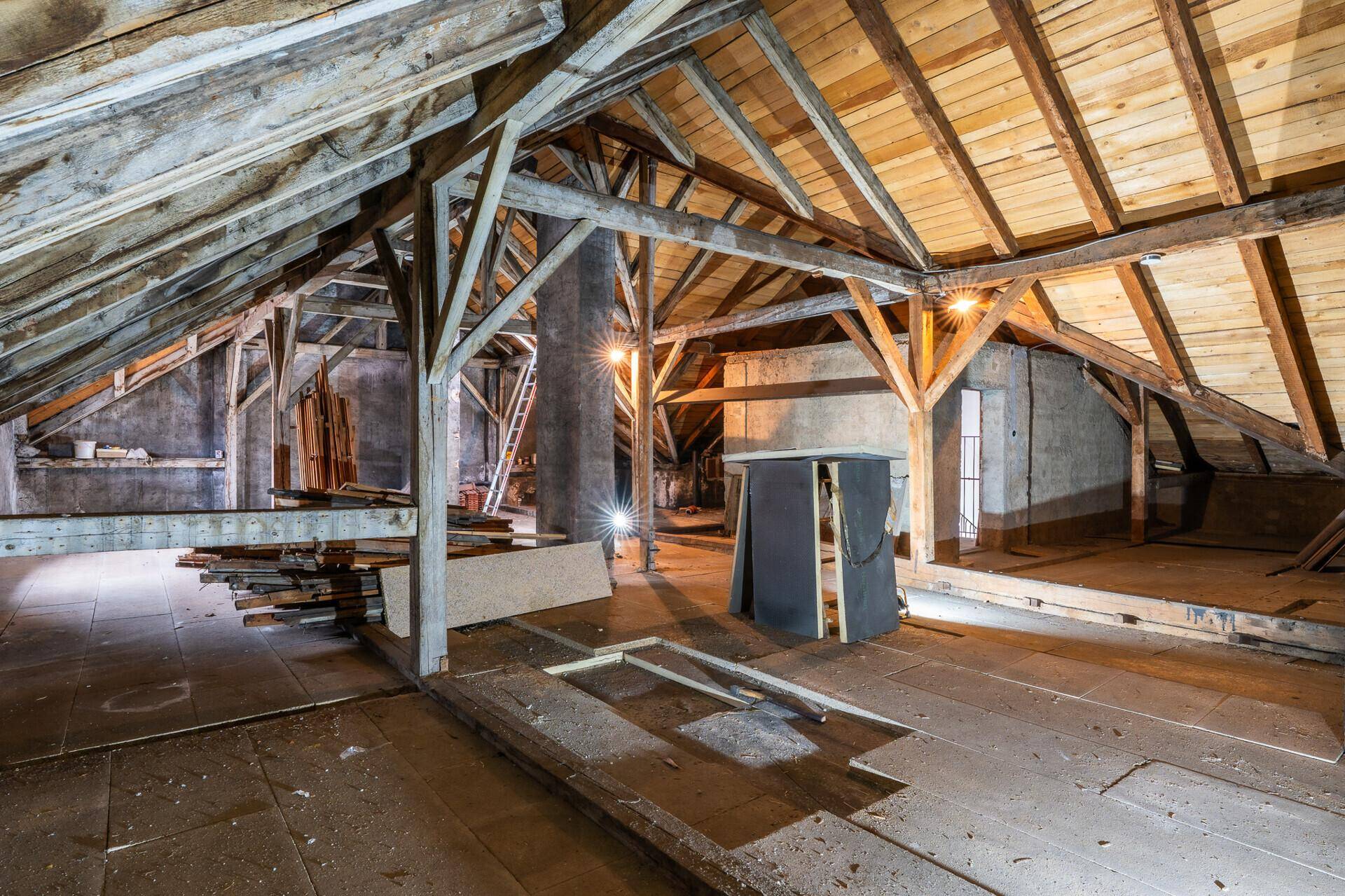 Unausgebauter Dachboden mit freiliegenden Holzbalken und viel Platz für kreative Gestaltungsideen.