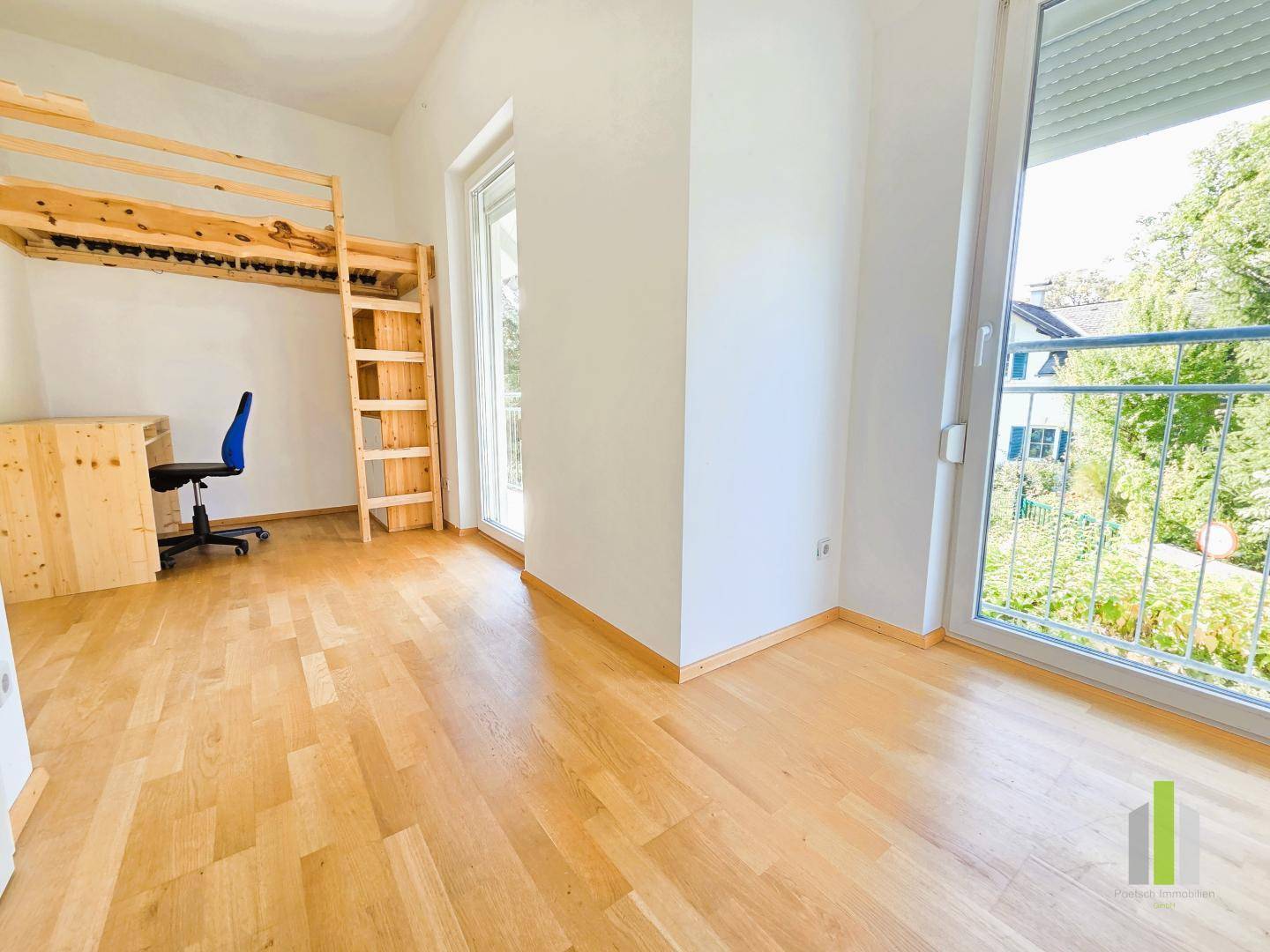 Helles Kinderzimmer mit Hochbett, Schreibtisch und großem Fenster mit Blick ins Grüne.