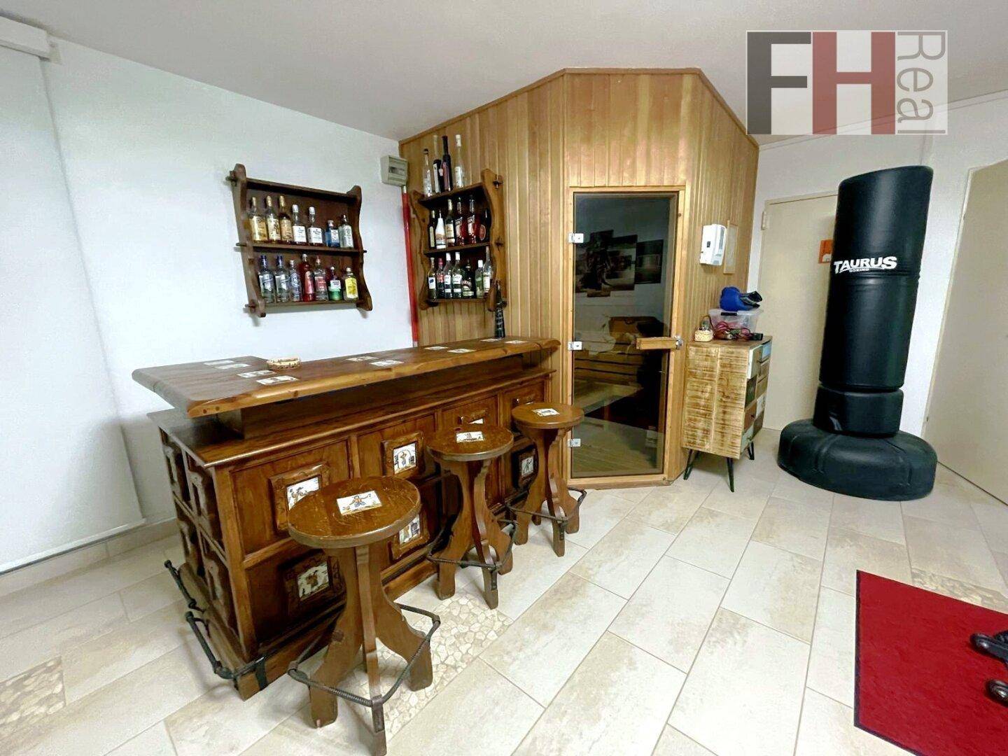 Privater Wellnessbereich mit Sauna und einer rustikalen Bar für entspannte Stunden.