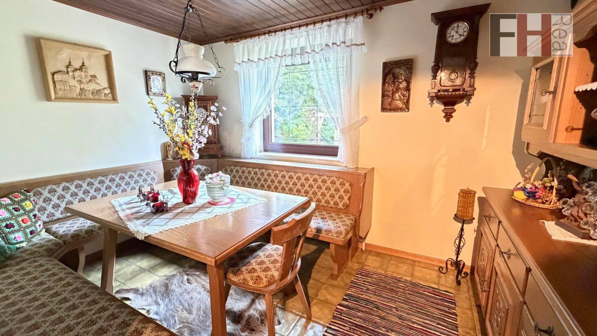 Gemütliche Essecke mit Eckbank, Holztisch und traditioneller Dekoration.