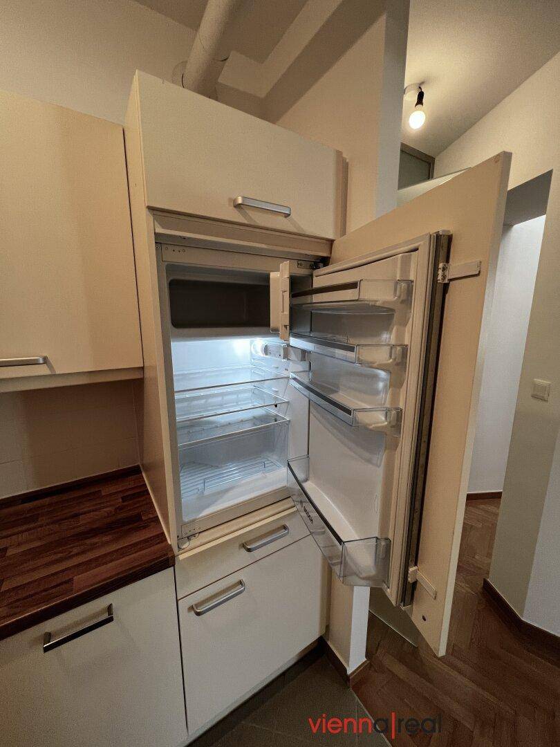 Offener Kühlschrank in der Küche, der den Innenraum und die Ablagefächer zeigt.