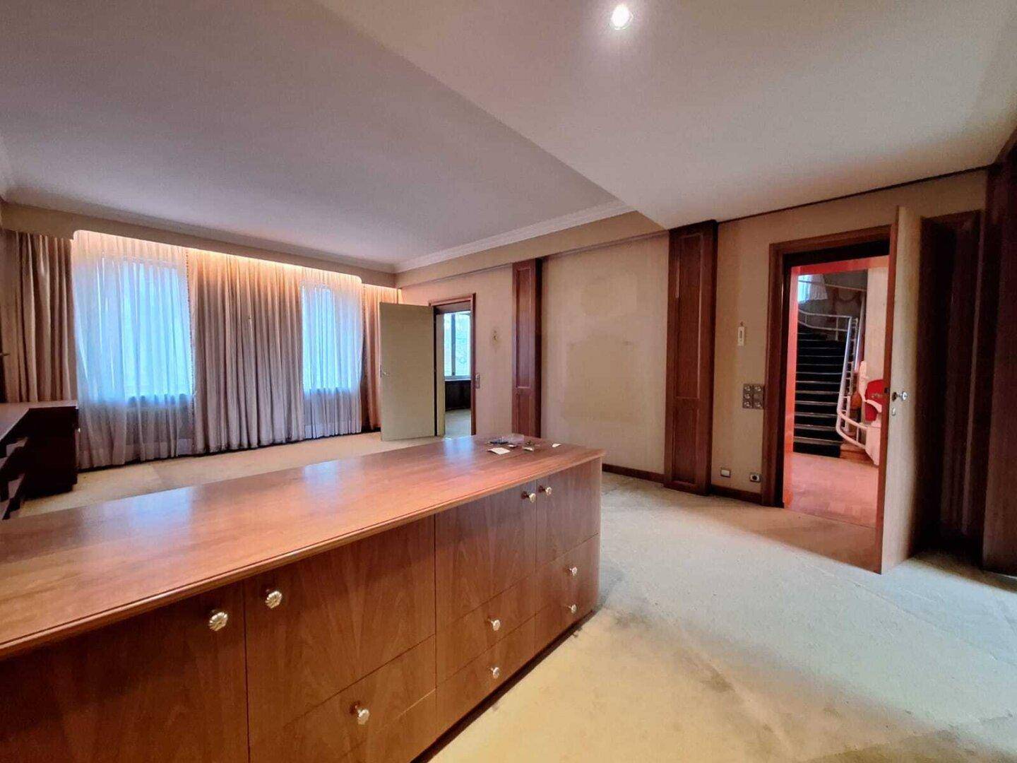 Geräumiges Büro mit Einbauschränken und Teppichboden, bereit für eine individuelle Gestaltung.