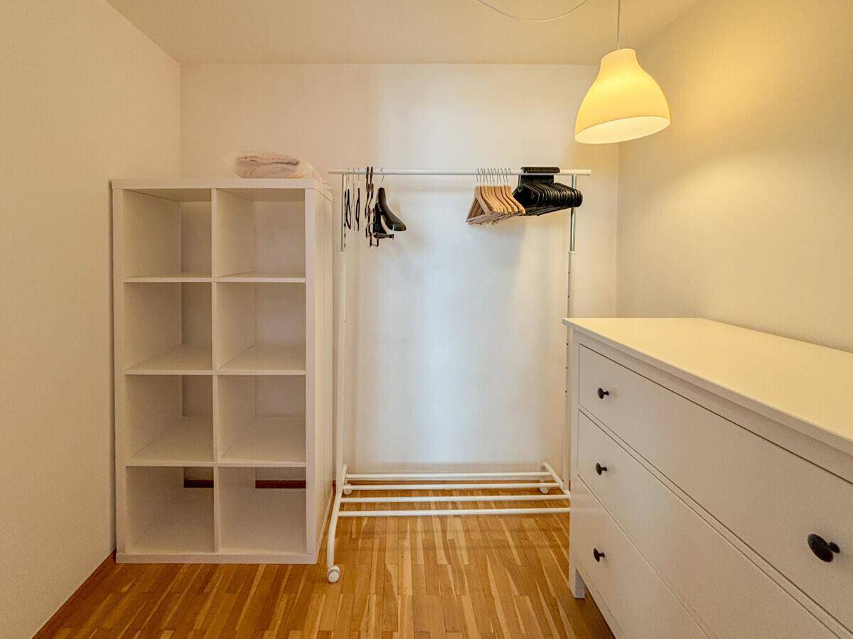 Praktischer begehbarer Kleiderschrank mit Regalen und Kleiderstange für ausreichend Stauraum.