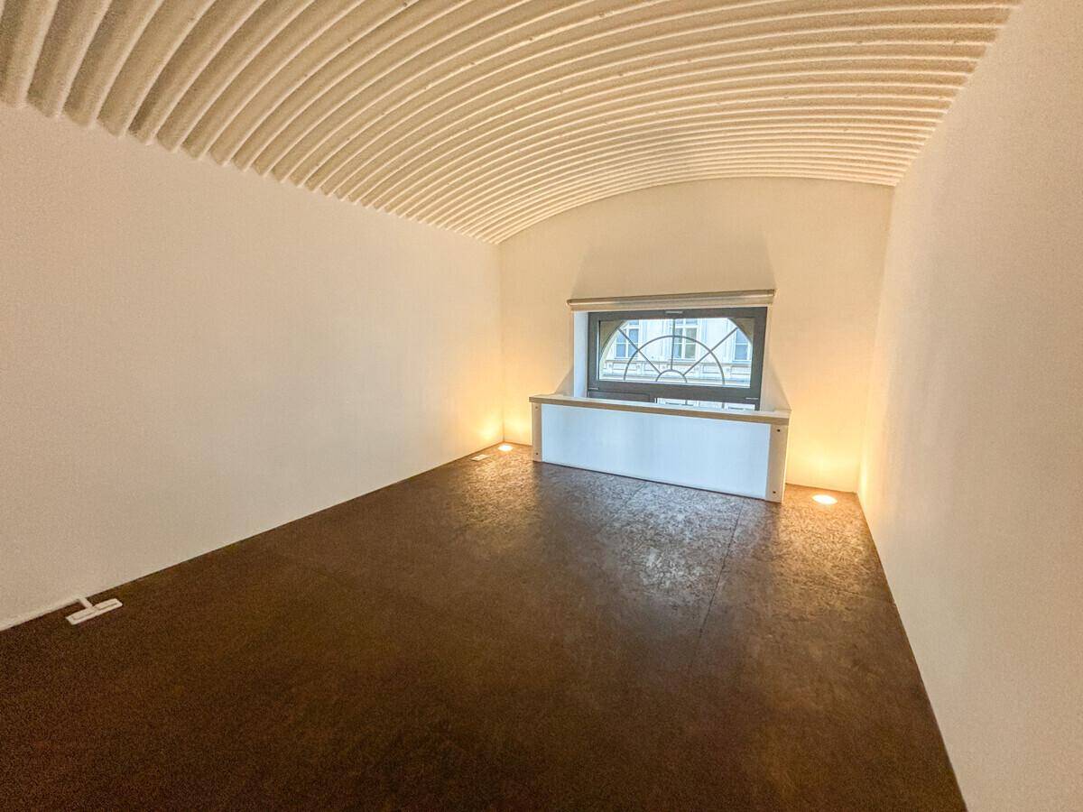 Kleiner Raum auf der Galerie mit gewölbter Decke, Fenster und indirekter Beleuchtung.