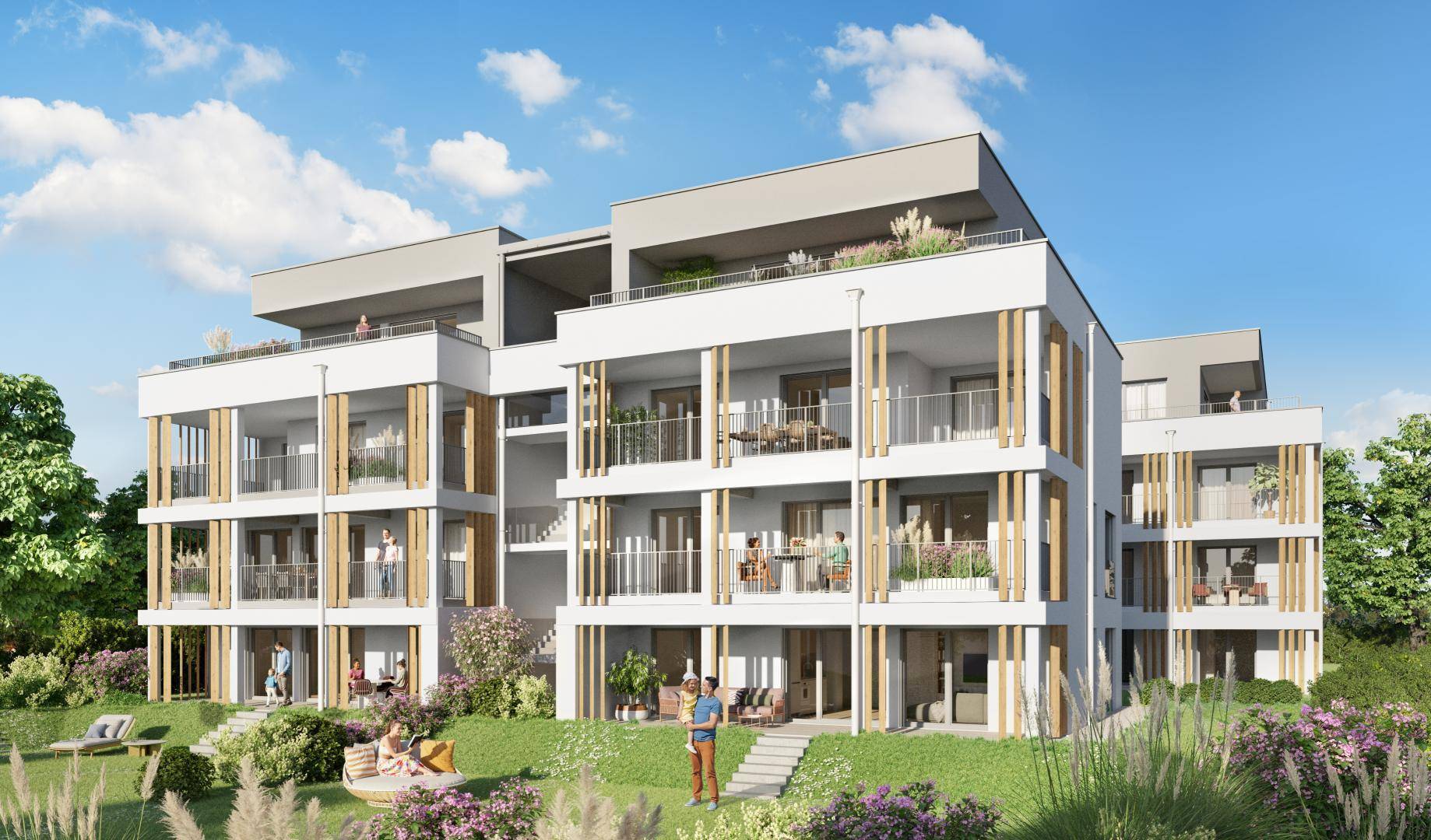 Modernes Mehrfamilienhaus mit klarer Architektur, mehreren Balkonen und umgeben von viel Grünfläche.