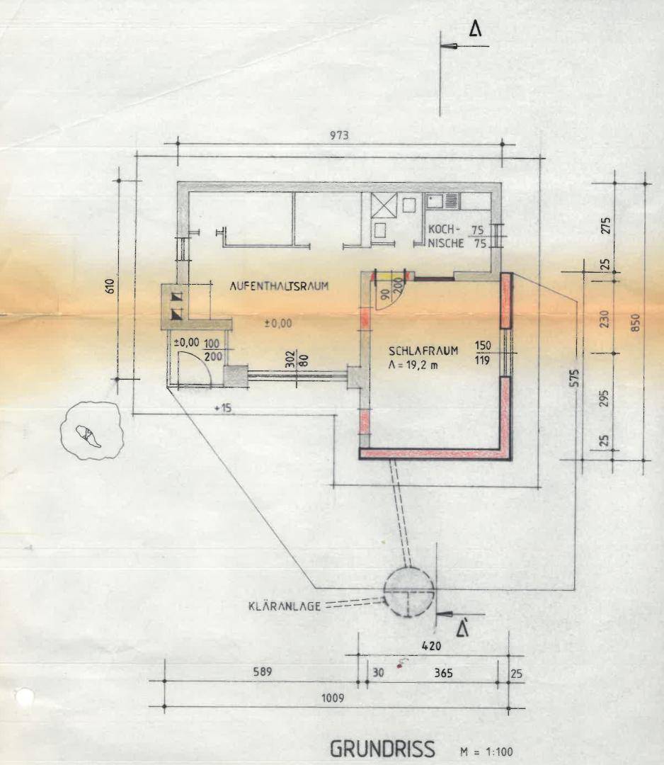 Grundrissplan eines kleinen Hauses mit Aufenthaltsraum, Schlafzimmer und Küche.