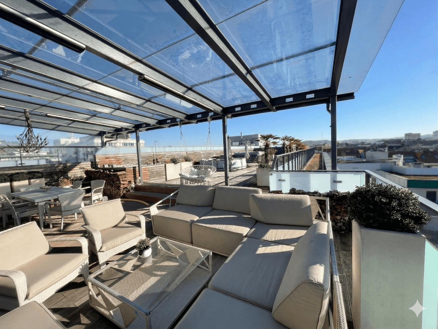 Weitläufige Dachterrasse mit bequemen Lounge-Möbeln und Whirlpool unter Glasdach.