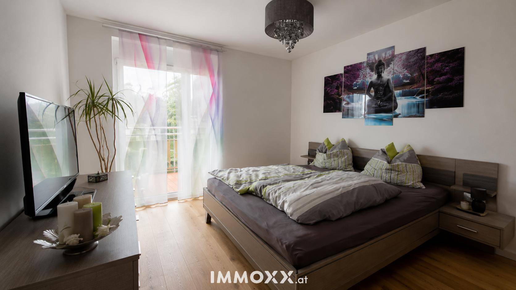 Helles Schlafzimmer mit Doppelbett, Holzboden und Zugang zu einem französischen Balkon.