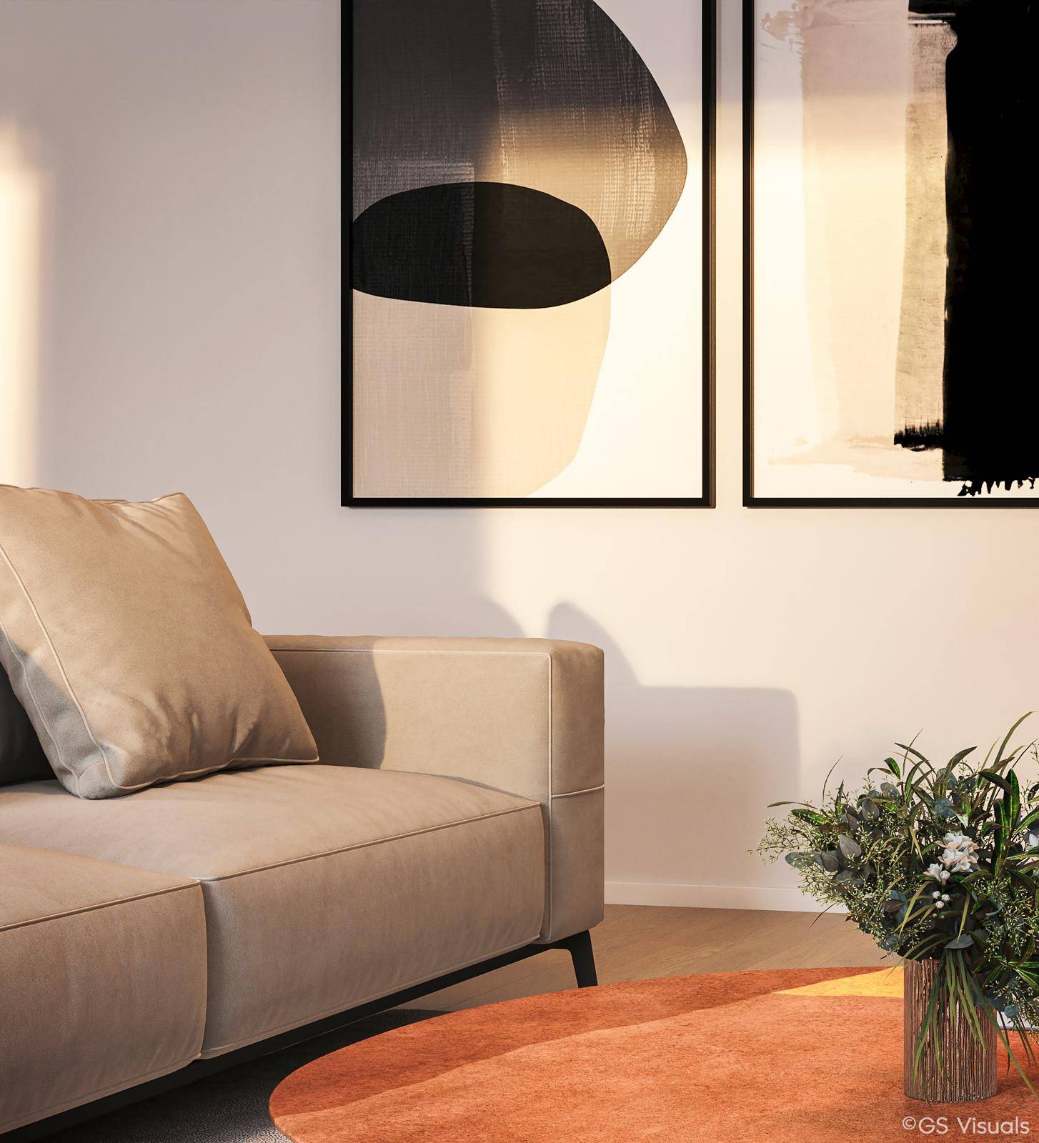 Detailaufnahme des Wohnzimmers mit beigem Sofa und modernen Kunstwerken an der hellen Wand.