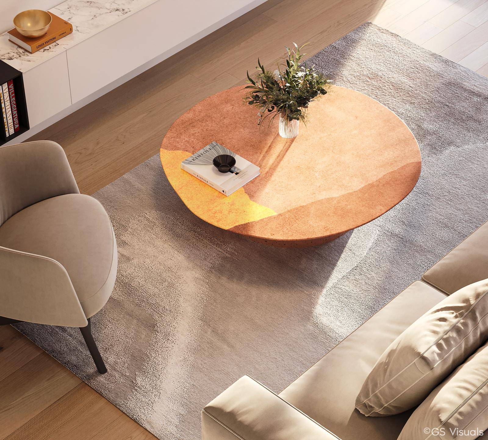 Detailansicht des Wohnzimmers mit modernem Sofa, Sessel und einem runden Couchtisch auf Teppich.