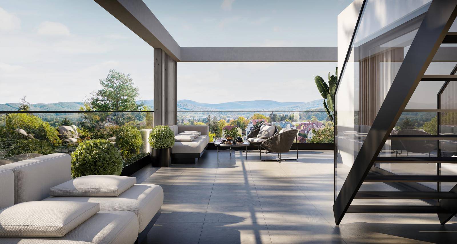 Geräumige Dachterrasse mit moderner Lounge-Möblierung und weitem Blick über die Landschaft und Berge.
