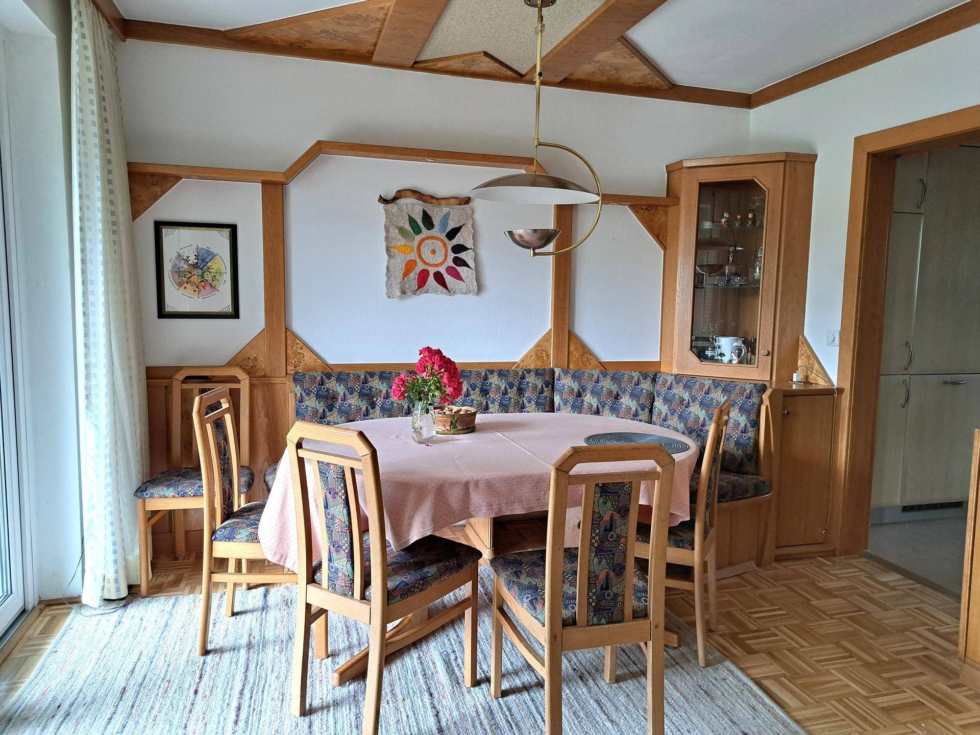 Traditioneller Essbereich mit Holzbänken, Esstisch und Parkettboden.
