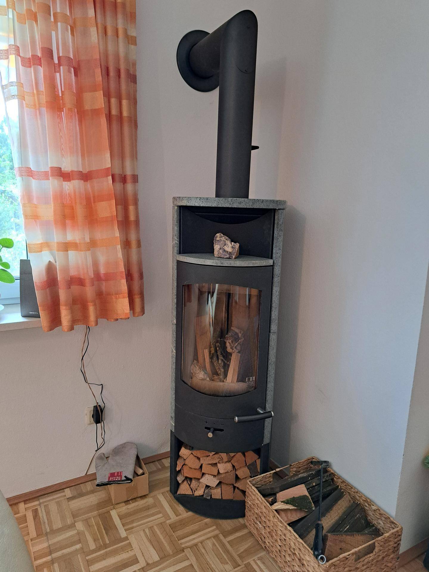 Moderner Holzofen im Wohnzimmer, der für zusätzliche Wärme und Gemütlichkeit sorgt.