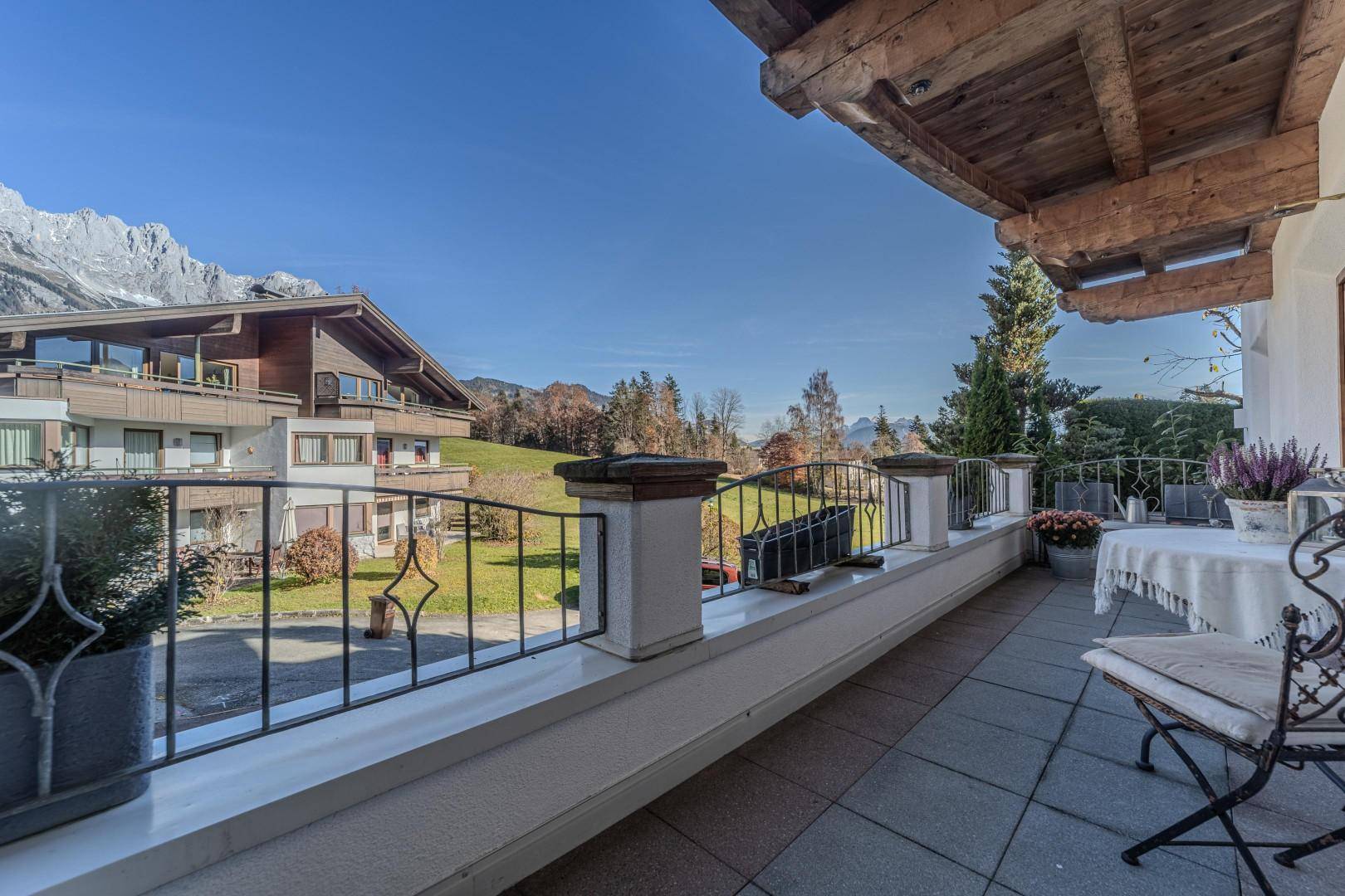 Großer Balkon mit Fliesenboden und Bergblick, ideal für entspannte Stunden.