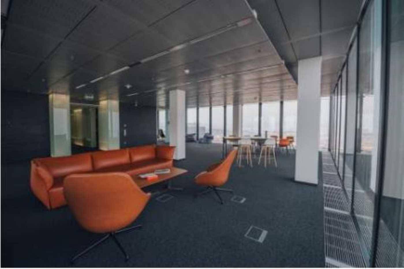 Komfortabler Loungebereich mit Ledersofa und Sesseln, ideal für informelle Treffen oder Pausen.