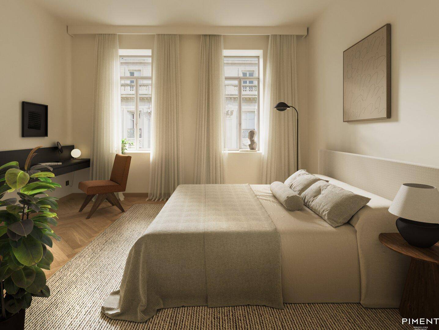 Gemütliches Schlafzimmer mit großem Bett, Schreibtisch und Fischgrätparkett.