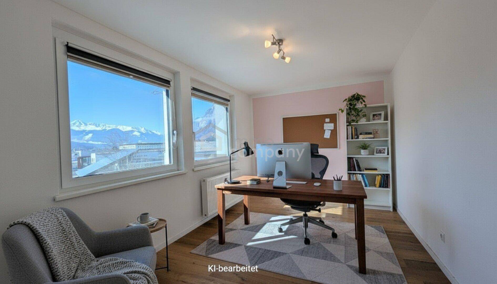 Funktionales Büro mit Schreibtisch, Bücherregal und großen Fenstern mit beeindruckendem Bergblick.