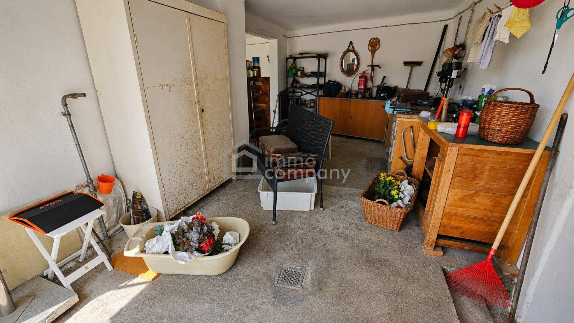 Geräumige Garage mit Stauraum und Werkstattbereich, ideal für Hobby und Lagerung.
