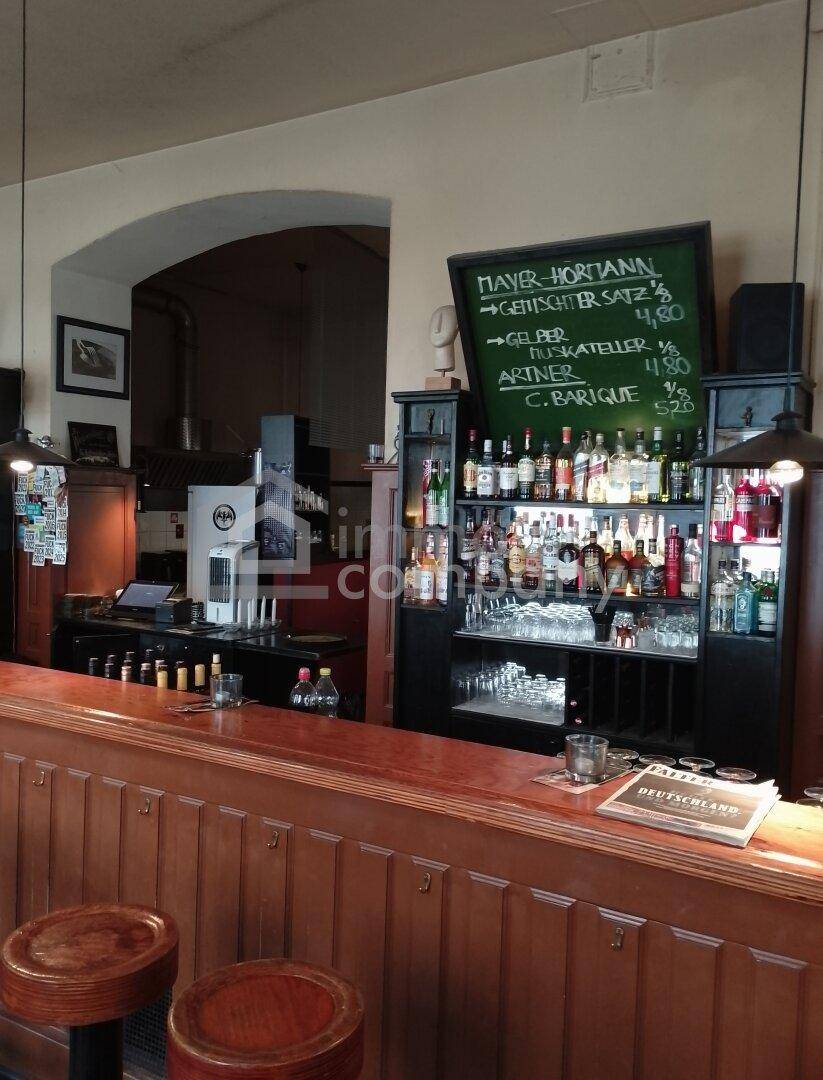 Detailansicht der Bar mit einer großen Auswahl an Getränken und einer Kreidetafel mit aktuellen Angeboten.