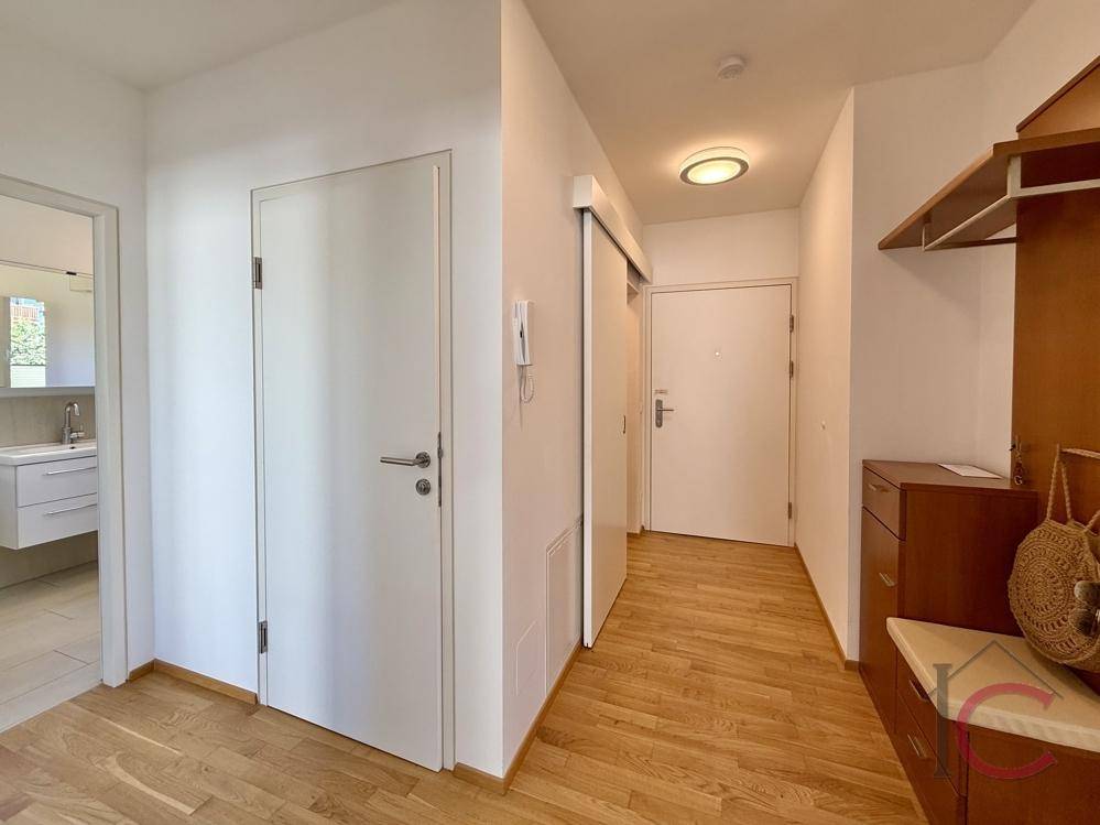 Heller Flur mit Holzboden und Zugang zu verschiedenen Räumen der Wohnung.