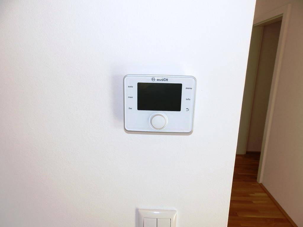 Modernes Bosch-Thermostat zur Steuerung der Raumtemperatur, an der Wand montiert.