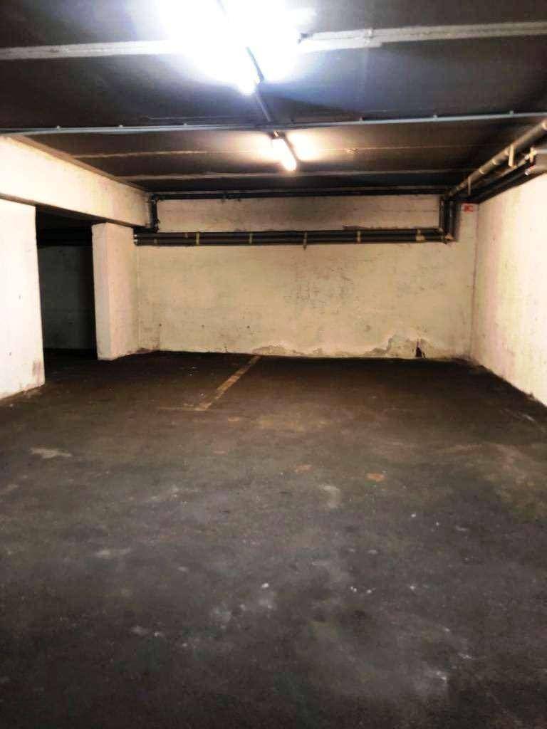 Geräumige Tiefgarage oder Lagerfläche mit Betonboden und sichtbaren Leitungen an der Decke.