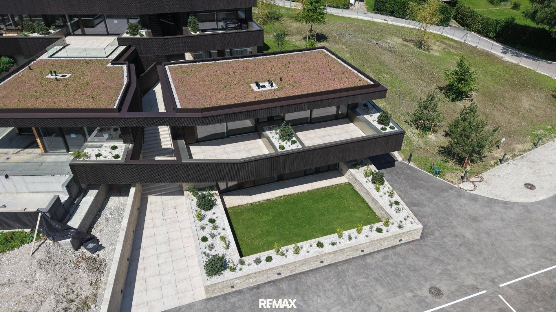 Luftaufnahme der modernen Architektur mit begrünten Dächern und Terrassenbereichen.