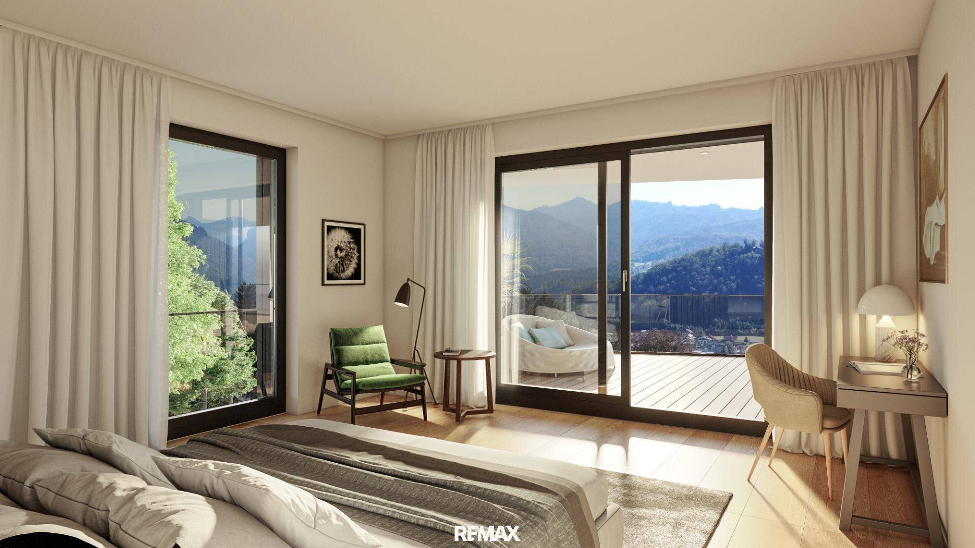 Helles Schlafzimmer mit großen Fenstern, Balkonzugang und Panoramablick auf die Berge.